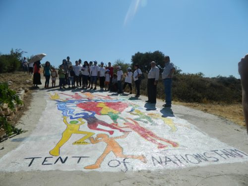 Some of our group standing by a newly painted mural on the way up to the farm.